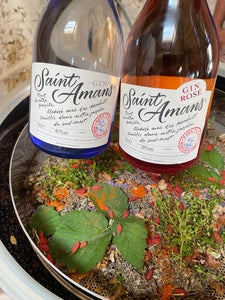 Our handcrafted gins: on the left, our Saint Amans Original gin, on the right, our Saint Amans Rosé Gin, both from our family-run gin distillery. French: Nos gins artisanaux : à gauche, notre Gin Original Saint Amans, et à droite, notre Gin Rosé Saint Amans, tous les deux issus de notre distillerie de gin familiale.