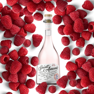 Our Rosé Gin bottle, surrounded by its iconic raspberries. French: Notre bouteille de Gin Rosé, entouré de ses framboises iconiques.