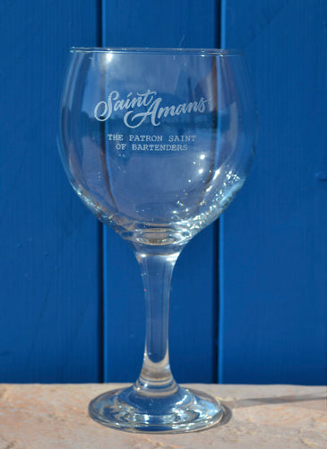 Our hand-engraved glass against a blue backdrop. The glass reads 